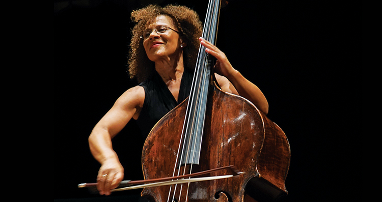 Chi-chi Nwanoku OBE playing her double bass against a black background. Photo by Eric Richmond.