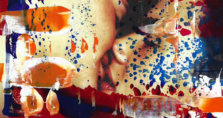 A photograph of two people kissing with splatters and smears of red and blue paint.