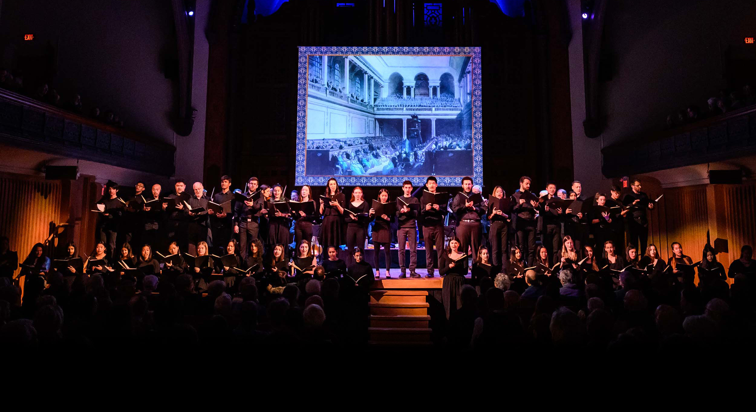 Large choir performing on stage