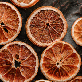 Sliced dried oranges on a black background.